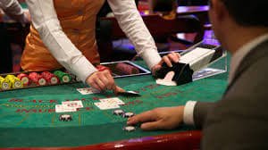 Baccarat table at M-World Championship with player and banker hands dealt
